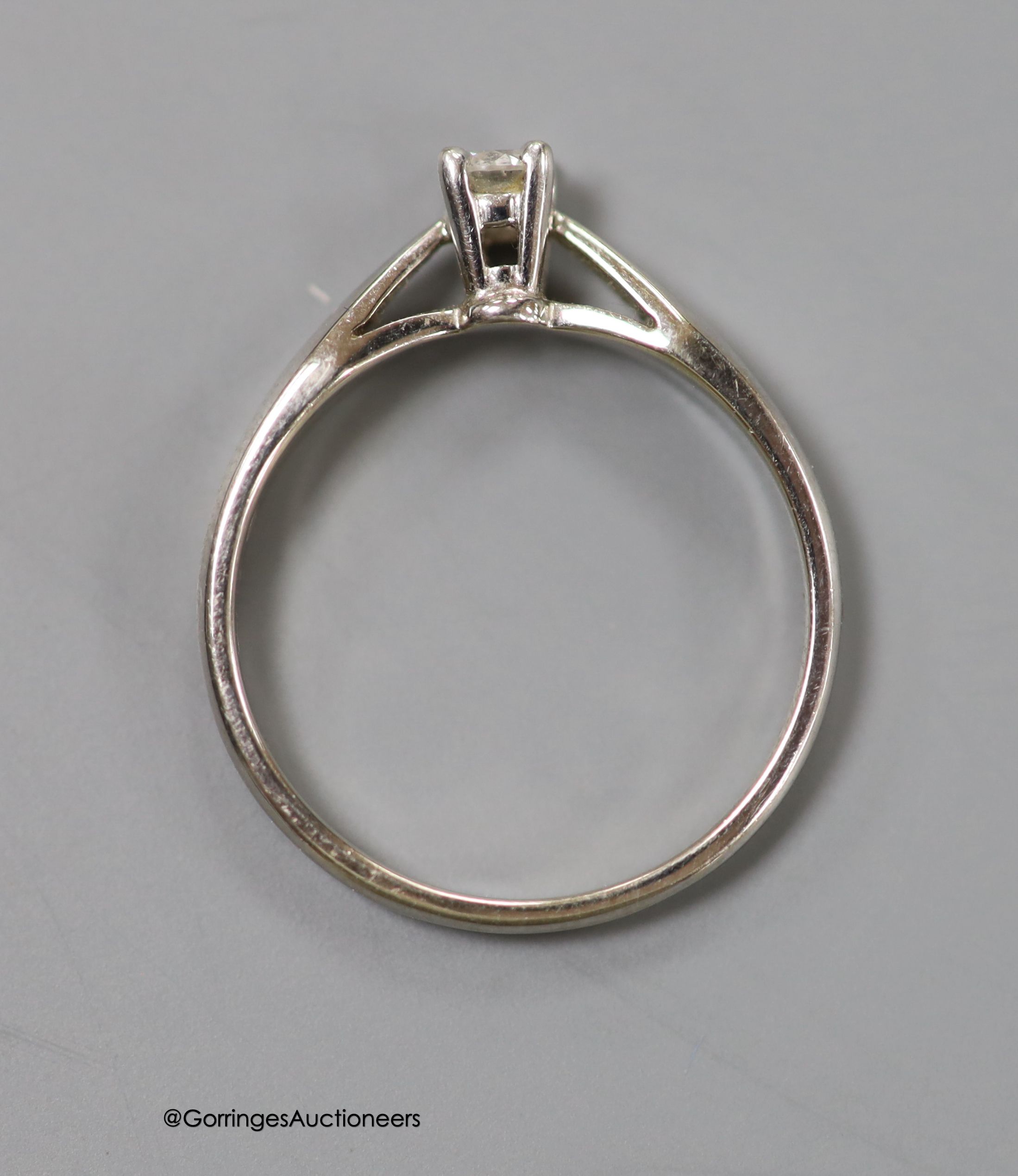 A modern 14ct white gold and solitaire diamond set ring, the stone weighing 0.15ct, size L, gross weight 2.1 grams.